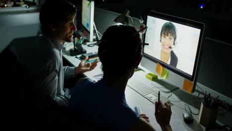 Rear-view-of-young-Caucasian-office-executives-making-video-conferencing-at-desk-in-modern-office-4k