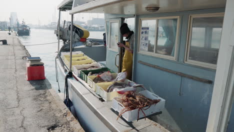 fisherman at a port selling fresh seafood