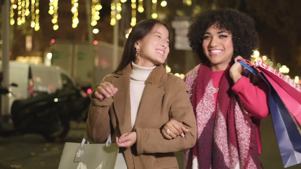 Two women shopping at night