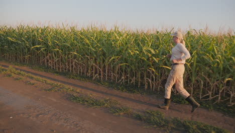 woman running through a cornfield