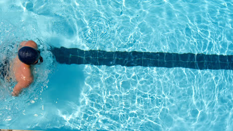 Male-swimmer-swimming-inside-pool-4k
