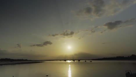 River-sunshine-in-the-morning-with-silhouette-boats-floating-at-Tavira-Portugal