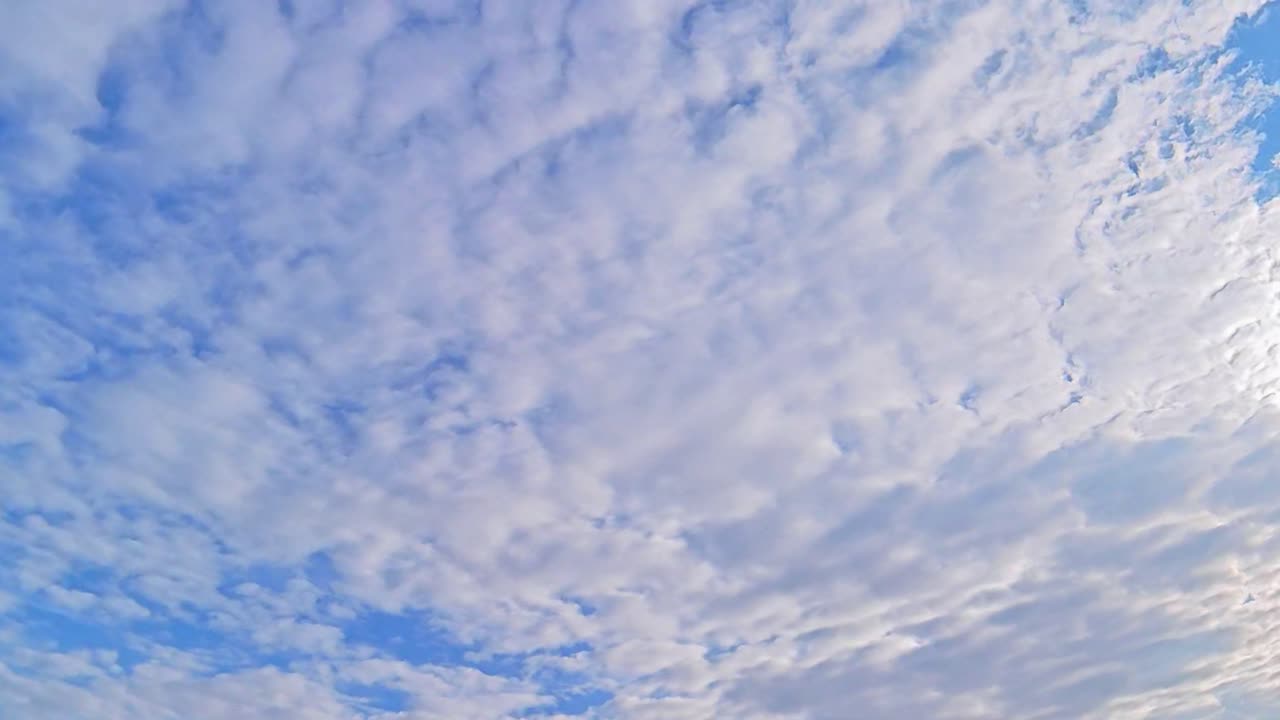 Fast-moving clouds in a blue sky create a dynamic visual experience