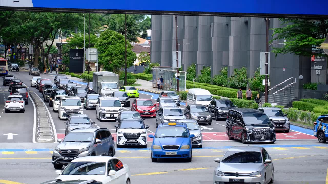 Neatly organised traffic moving and free flowing on 5 lane highway road in capital city of Kuala Lumpur Malaysia