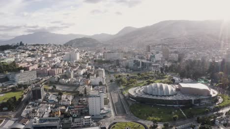 drone shot of the city of quito, ecuador during quarantine. overlooking avenue twelve of october and casa de la cultura. the virgin of quito and panecillo in the far back. some cars are transiting.