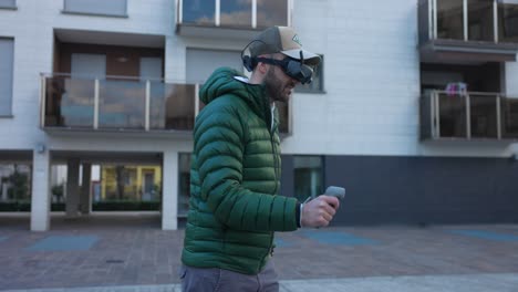 young male drone pilot wearing drone goggles and controlling remote of fpv drone