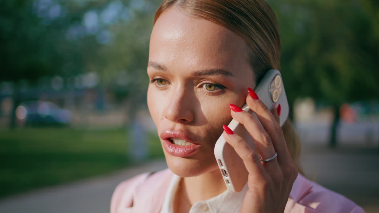 la señora jefe hablando por teléfono móvil de pie en la calle de cerca. la mujer discutiendo temas