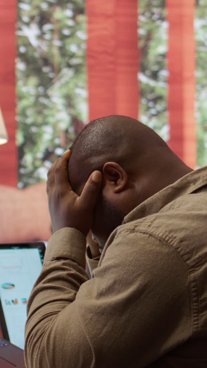 Frustrated African American Man Working on Laptop