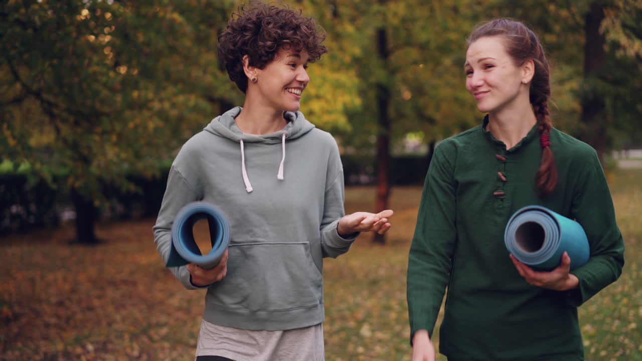 Two Women Walking in the Park with Yoga Mats