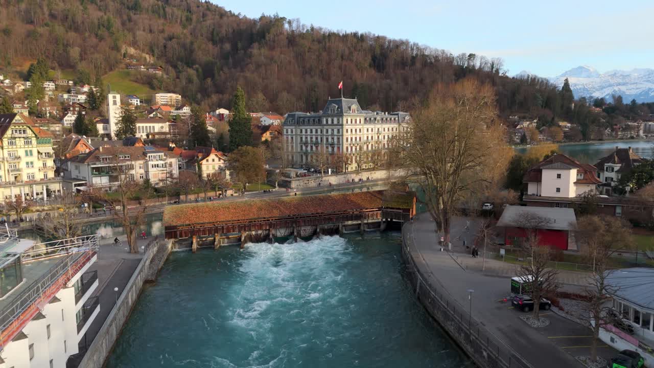 Flowing sluice and bridge of river Aare in historic Thun town center