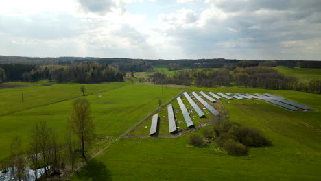 aerial truck shot of photovoltaic solar units producing renewable energy during sunny day in nature