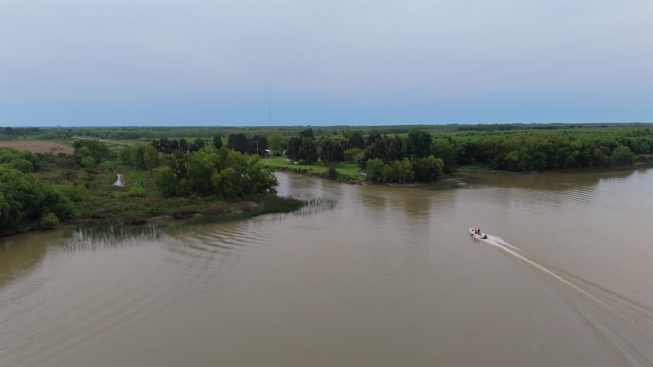 Aerial view of boat navigating through river ecosystem in South America.