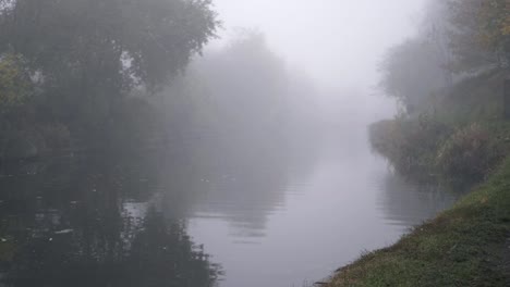 empty lonely canal and pathway in a foggy winter wide