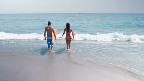 two surfer walking on the sea with surfboard