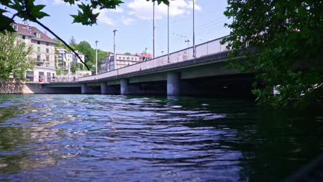 waves from passing passenger ship on river limmat at city of zürich on a sunny late spring day.