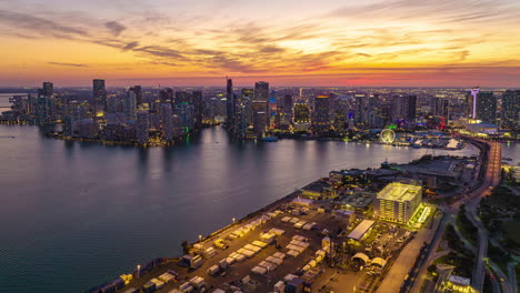 Breath-taking-hyper-lapse-shot-large-city-at-sunset.-Colourful-sky-above-modern-high-rise-buildings-on-sea-coast.-Miami,-USA