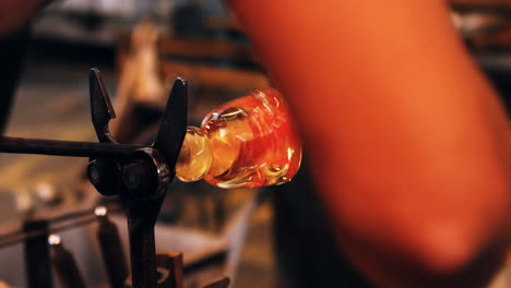 glassblower shaping a molten glass