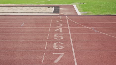 disabled mixed race man with prosthetic legs running through a finishing line on race track