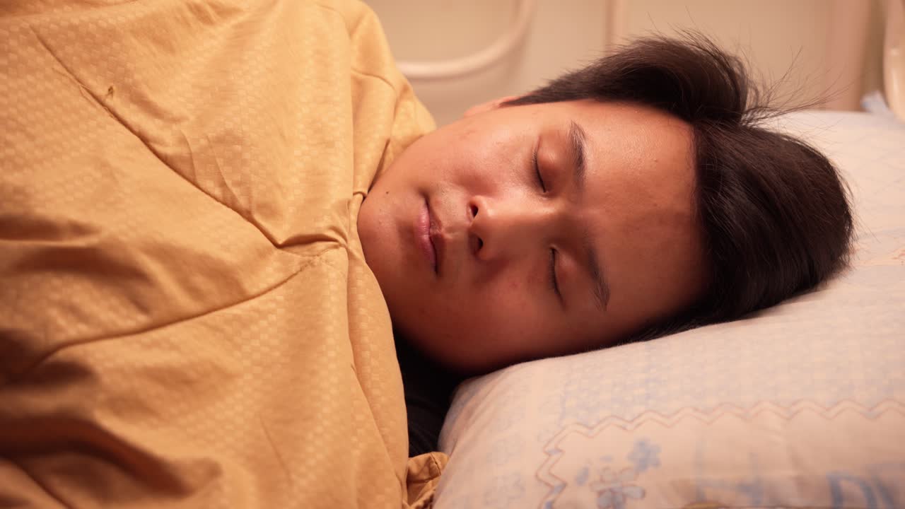 Serene Chinese man resting, conveying tranquility and peaceful sleep