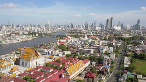 sliding drone shot of wat kanlayanamit on a warm sunny day in bangkok, thailand