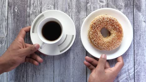 fresh bagel bread and cup of tea on table