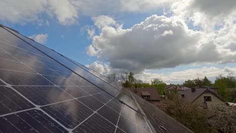 timelapse of cloud reflection on solar panels daylight and shadows moving across sloped roof, suburban home