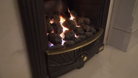 Warm,-cosy-burning-fireplace-surrounded-with-marble