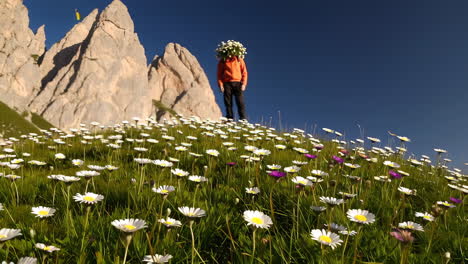 person with bouquet of flowers in a mountain meadow