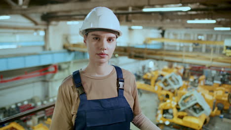 portrait of female technician at work in industrial factory