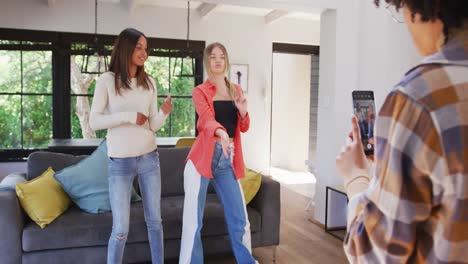 happy diverse teenager girls friends dancing and making vlog at home, slow motion