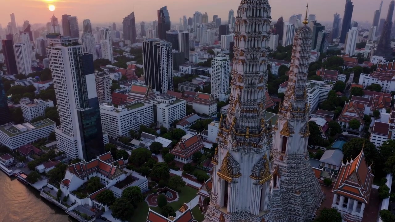 Aerial View of Wat Arun Temple and Bangkok Skyline at Sunset
