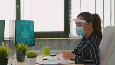 mujer con máscara facial comprobando los informes