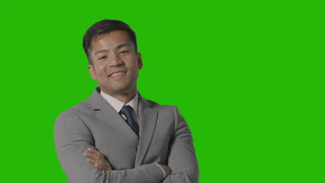 Portrait-Of-Businessman-In-Suit-Against-Green-Screen-Smiling-At-Camera-2