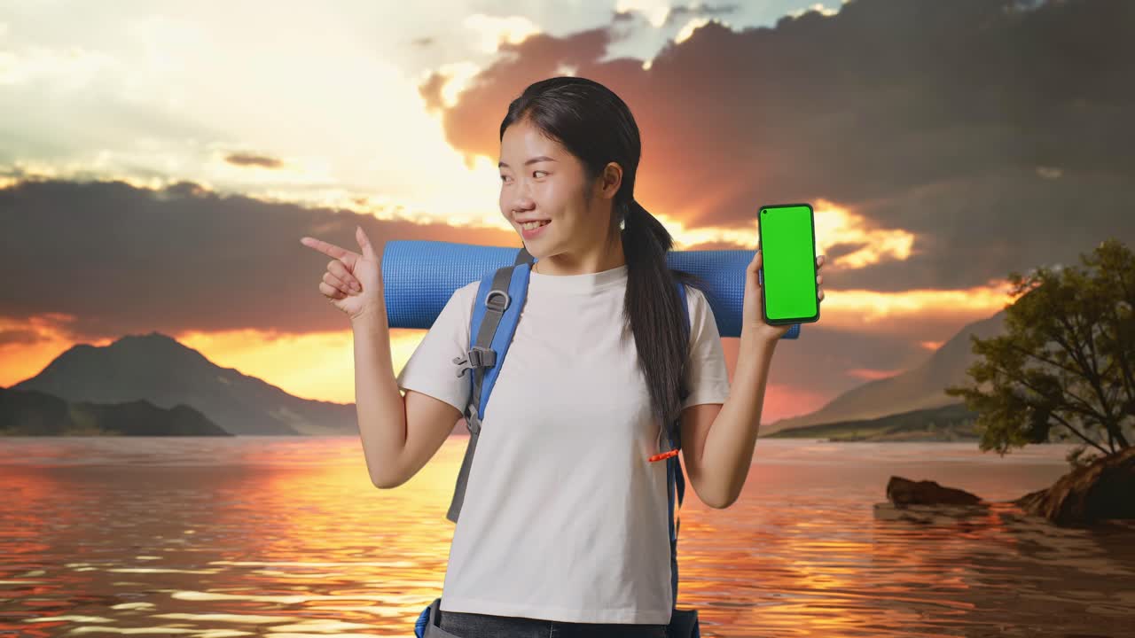 Woman Traveler with Green Screen Phone at Sunset Lake