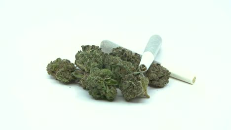 marijuana joints and bud rotating on a white background