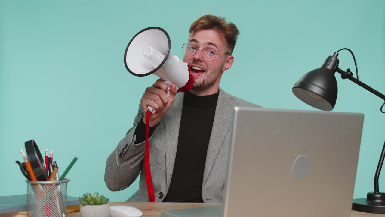 Business man talking with megaphone proclaiming news loudly announcing advertisement welcome