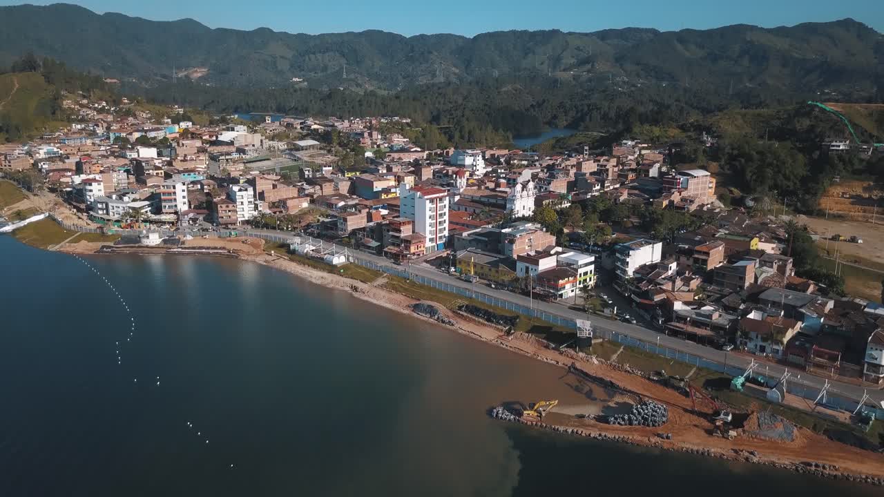 toma aérea de un dron que revela la ciudad cerca del lago en el peñón en guatapé, colombia