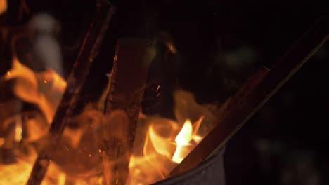 kindling openly burns in a metal barrel