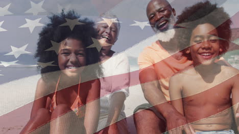 animation of flag of usa over senior african american couple with grandchildren on beach