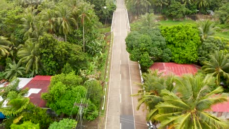 aerial drone of road and village on an island in the philippines 4k