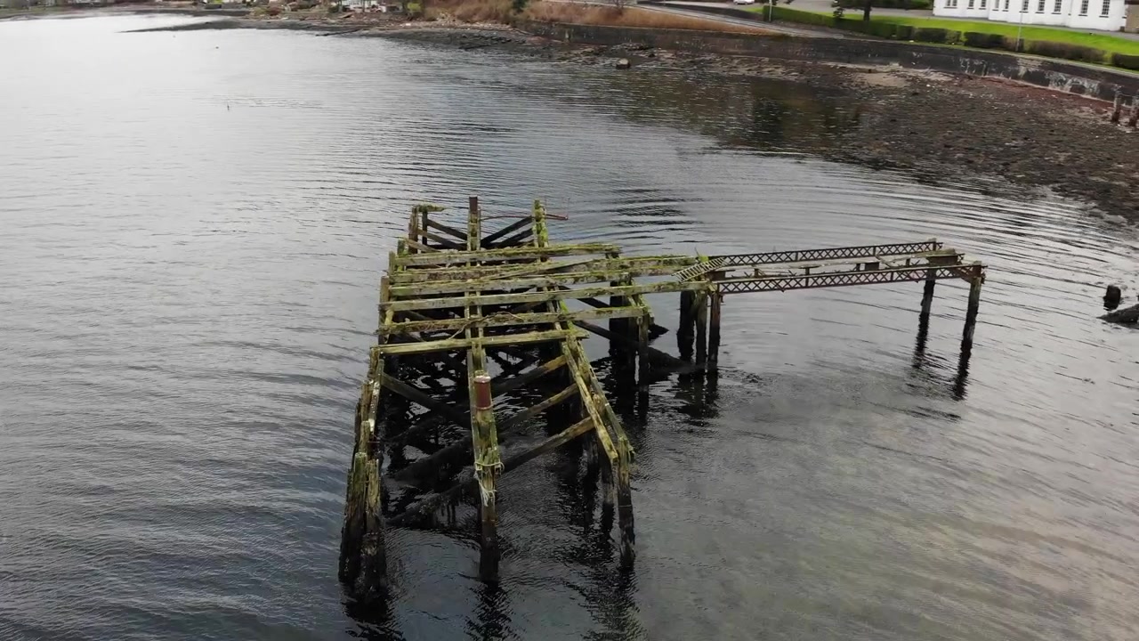 Drone Orbit Shot Around Old Dilapidated Wooden Jetty Pier on Loch Long Scotland