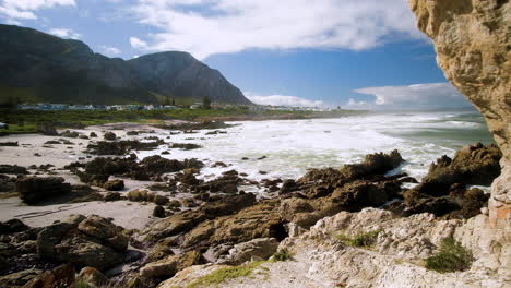 scenic coastal view of hermanus coastline with waves crashing onto rocky beach