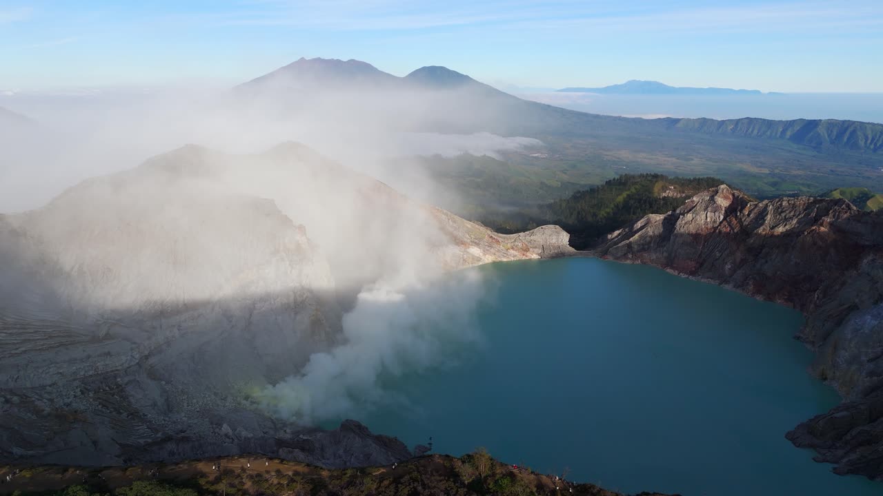 Drone footage of Kawah Ijen Volcano Crater, with the turquoise acidic lake and sulfur mine in view