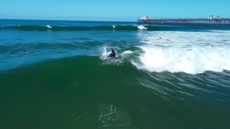 surfer does snap at oceanside pier