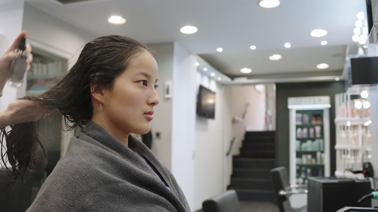 Woman getting her hair styled in a salon