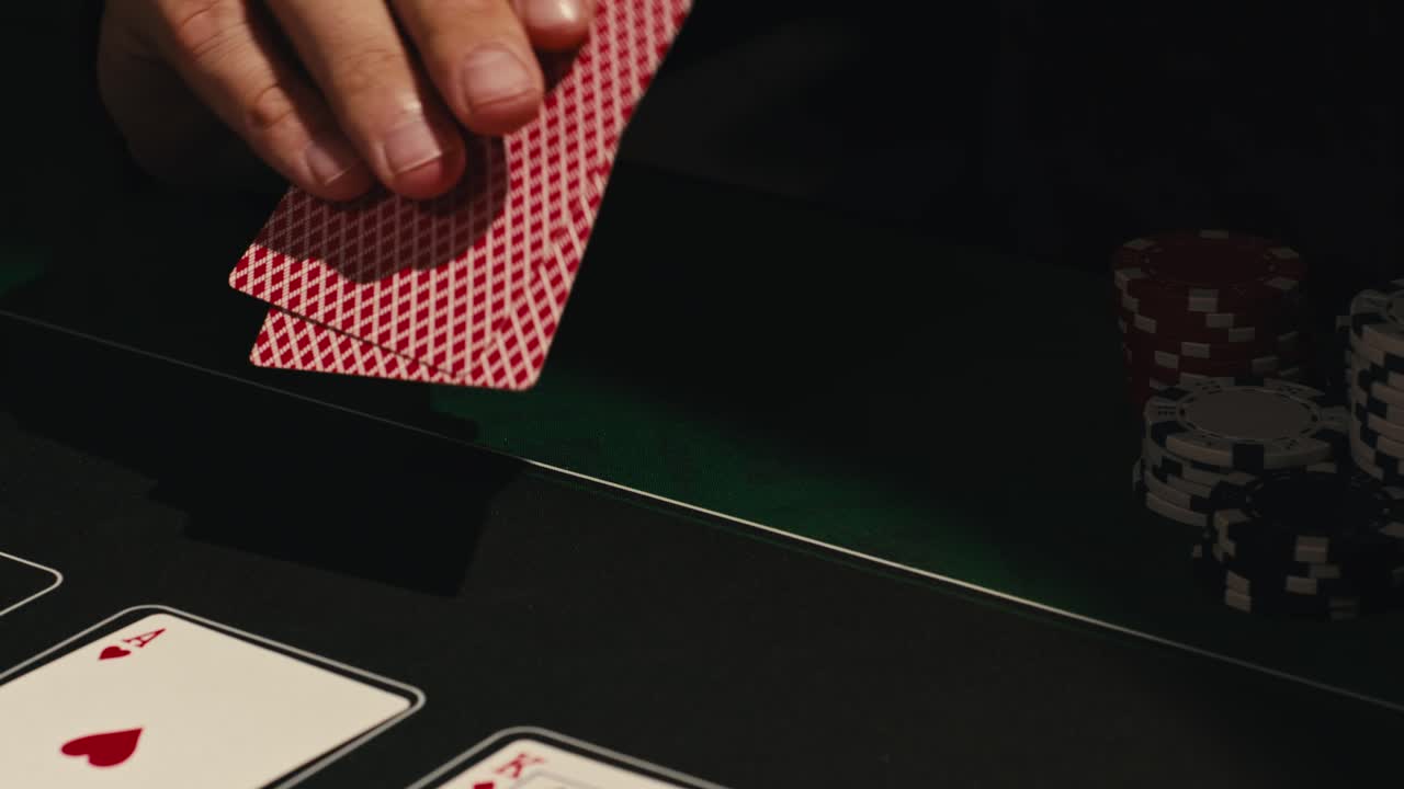 Hands managing poker chips on green table, reflecting intense poker gameplay with the element of chance and skill