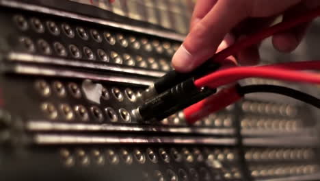 patching cables to patchbay in recording studio