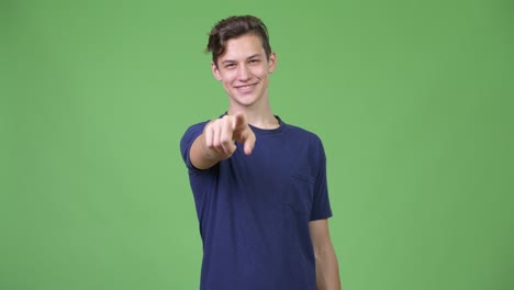young handsome teenage boy pointing to camera