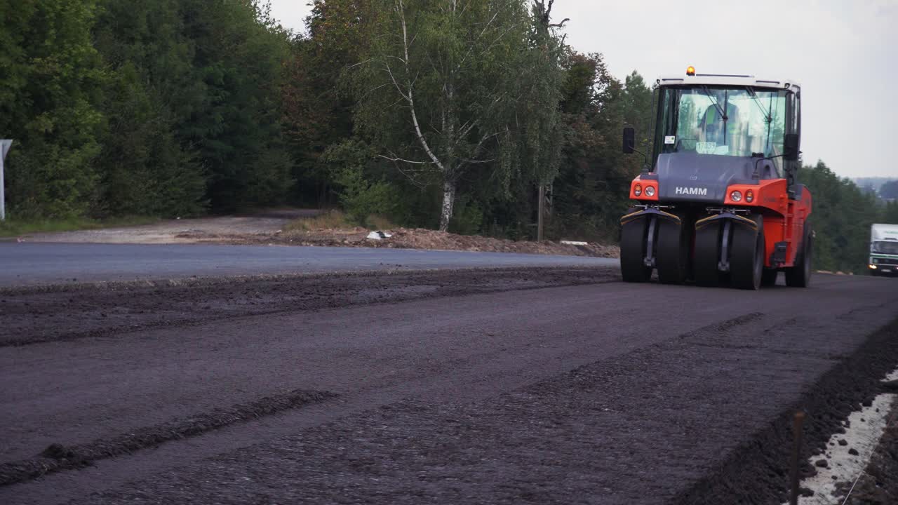 VINNYTSIA, UKRAINE - SEPTEMBER 10, 2018: sphalt paver applying asphalt on the repaired city road