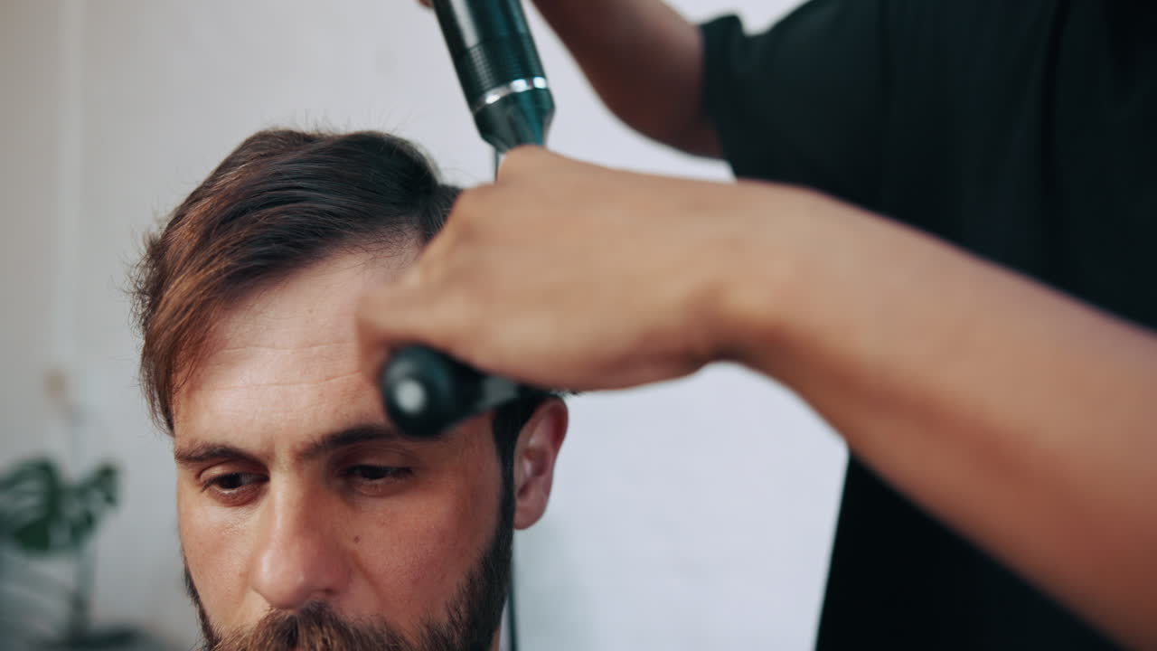 Barber Styling Man's Hair with Blow Dryer and Brush